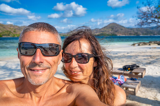 Caucasian couple relaxing and having fun together on a beautiful Indonesian beach