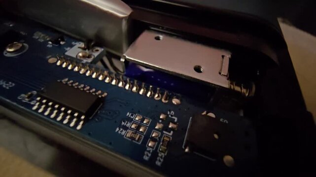 Close-up view of printed circuit board PCB and rechargeable lithium polymer battery inside a smart time-lock box electronics assembly