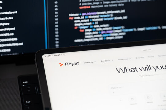 Replit Ai company web page on program code background