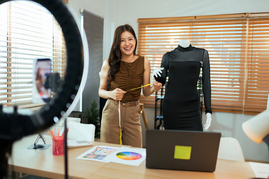 Young woman vlogging fashion design and dressmaking online