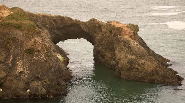 Discover the arch at Mendocino Headlands State Park on a foggy day along the Pacific Ocean coastline. Enjoy this natural landmark.