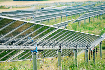 Fototapeta premium Motorized solar tracker mechanism with torque tube assembly and photovoltaic panel racking structure for renewable energy asset management