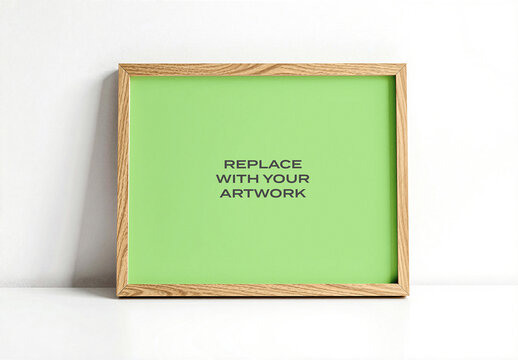 Framed vertical poster mockup with placeholder background displayed on a white surface against plain interior wall, realistic art presentation for print or digital display