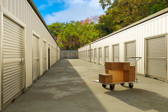 Self storage facility. Rows of secure rental storage units with roll-up doors provide space for personal belongings, boxes, furniture and business inventory.