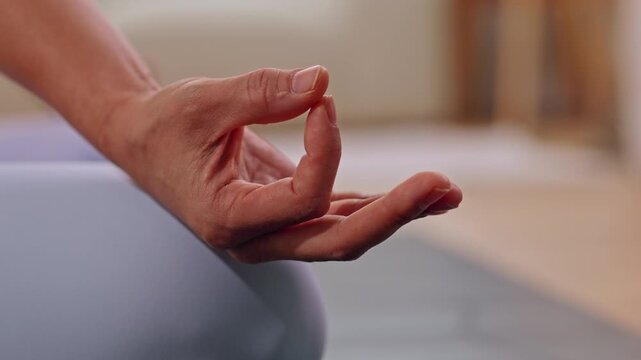 Hand meditation yoga mudra finger calm wellness relaxation mindfulness gesture indoor practice on mat with open palm close up soft background peaceful mood mindful exercise