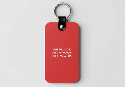 Rectangular keychain mockup with metal ring and black leather strap displayed on a light gray background, Template, flat lay product presentation for branding graphic design