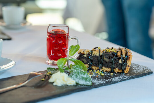 Chocolate cake dusted with powdered sugar served in elegant restaurant dessert plate