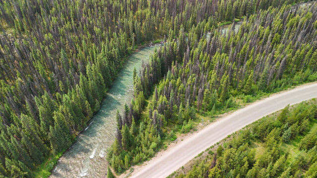 High altitude drone capture of Maligne River flowing through alpine scenery
