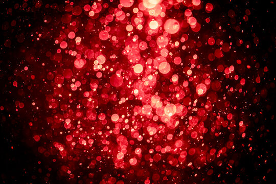 Blurred photo with red dots visible glittering, shining brightly look and feel luxurious