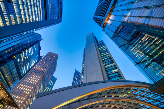 Tokyo&rsquo;s Shimbashi at night, showcasing high-rise buildings, bustling business district, and vibrant urban lights