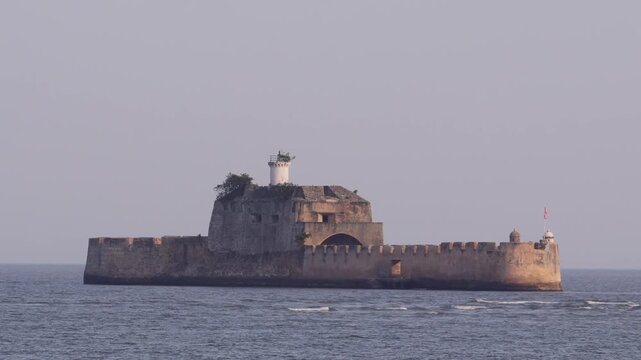 Pani Kotha Sea Fort and Lighthouse in the Arabian Sea, Diu, India. Historic Fortim do Mar Portuguese Island Fortress and Former Prison in Diu. Panikotha Surrounded by Ocean Waves.
