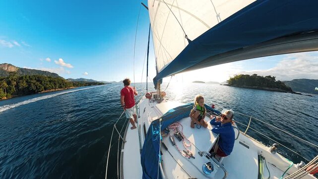 Family sailing on the small sailing boat in Brazil