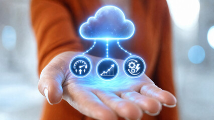 Obraz premium A person holding out their hand with a glowing cloud icon and three smaller icons representing data and performance metrics above it