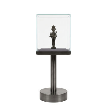 Ancient Egyptian artifact displayed in a modern glass museum case on a pedestal