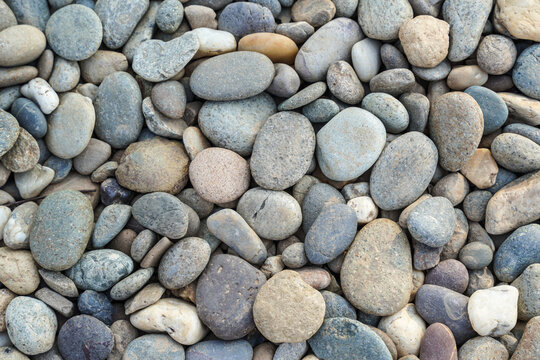 Smooth River Pebbles and Rounded Stones Lying in a Dense Pattern, Natural Textured Background for Zen Wellness and Outdoor Landscape Design