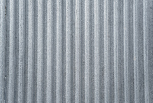 Corrugated metal sheet texture with vertical lines and industrial pattern background