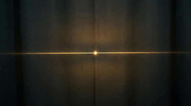 Horizontal golden light beam with central lens flare on a dark wall texture horizontal abstract