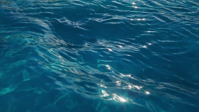 Deep blue ocean waves move with soft sunlit caustic reflections. Seamless loop for sea backgrounds, travel promos, and motion design. 3d render motion.