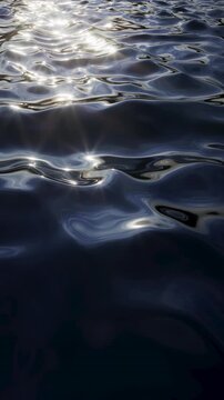 Dark blue water surface with glossy vertical wave motion and highlights. Seamless loop for elegant marine backgrounds and promos. Vertical 3d render video.