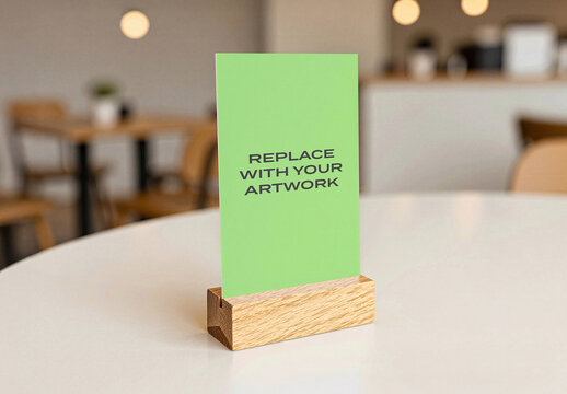 Vertical poster mockup in a wooden stand on white table modern cafe interior with blurred background, realistic graphic design presentation for branding, advertising, or print display, template