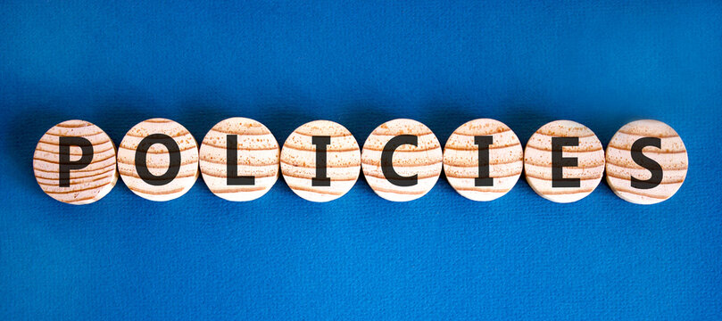 Policies word symbol. Concept word Policies on beautiful wooden circles. Beautiful blue background. Business support help policies word concept. Copy space.