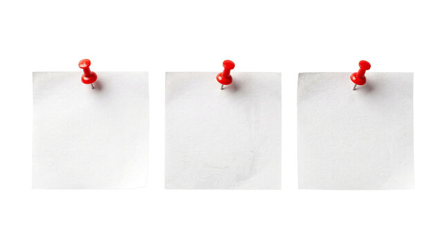 Three white square sticky notes attached with red push pins for office task reminders.