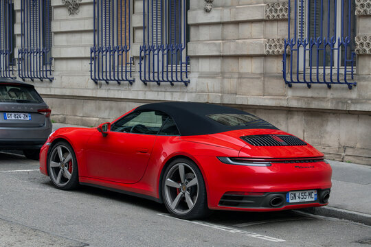 Nancy, France - January 20th 2026 : View on a red Porsche 992 Carrera 4S Cabriolet parked on a street.