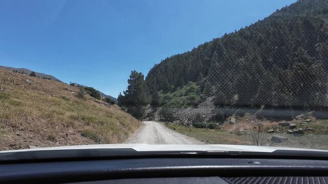 Driving on a dusty mountain road in Montgarri Pyrenees