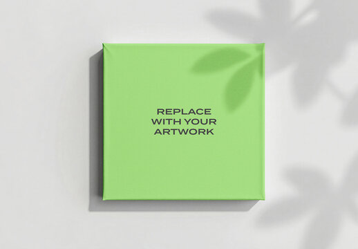 Square canvas mockup with fabric surface displayed on a white wall, realistic art presentation featuring leaf shadow, interior design template for artwork display and product visualization