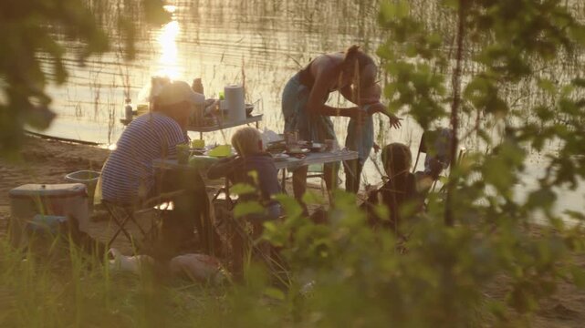 Family camping on the lake with kids