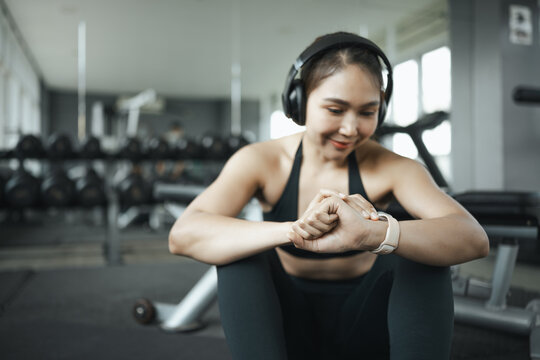 stretching smartwatch timing with recovery monitoring; a woman using a smart watch. stretching guides buyer choices, smartwatch frames the scene, and timing adds useful meaning. For useful context.