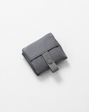 gray compact reusable shopping bag folded with strap closure