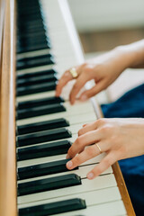 Adult womans hands playing the piano © Jenisse