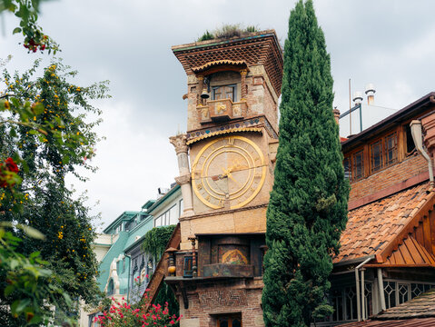 View of the whimsical Rezo Gabriadze Clock Tower with its golden clock face and intricate architectural details in Old Tbilisi, Tbilisi, Georgia.