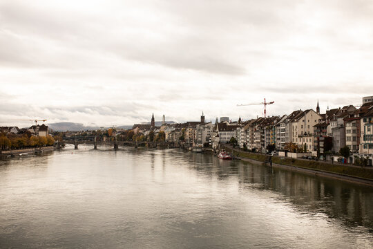 Riverside cityscape in Basel, Switzerland on an overcast day