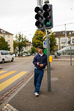 Man wait at pedestrian crossing in Switzerland