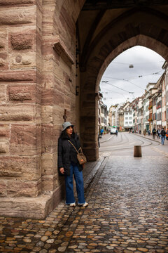 Woman beneath historic arch on a Switzerland city trip