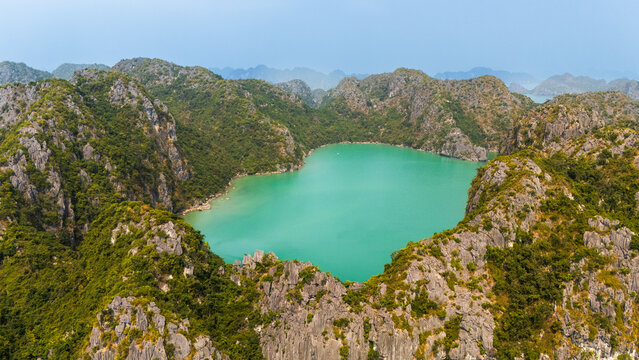 Turquoise lagoon among limestone cliffs on Cat Ba Island