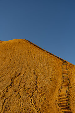 View of the wooden staircase leading up the steep orange volcanic slopes of Kerlingarfjoll in Hrunamannahreppur, Iceland.