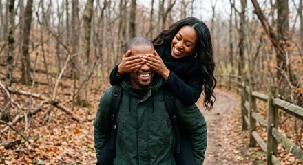 Fototapeta premium Happy African American Couple Piggyback Ride in Autumn Forest