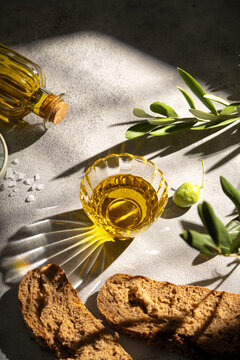 Olive oil with bread and olive in sunlight