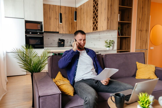 Man managing remote work call from home with laptop