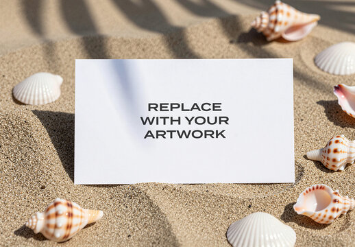 Vertical stationery mockup featuring a blank white card placed on sandy beach surrounded by seashells and palm shadows, realistic outdoor presentation for graphic design, branding, advertising