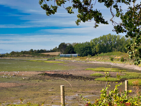Passenger Train Traveling Along the Scenic Exe Estuary Near Exmouth in Devon