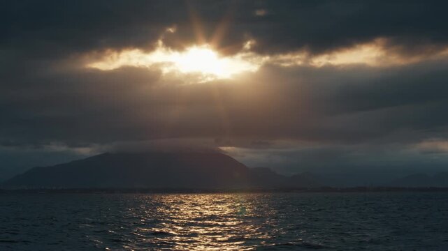 Remote view of the coastline as seen from the moving sailing vessel. Brazilian shore during sunset time as seen from a boat