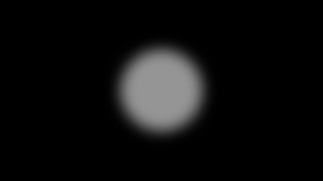 Abstract white glowing circle light effect centered on solid black background video a soft circular positioned in the center of a field glow center motion spot blur