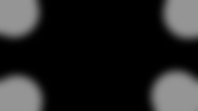 Four white glowing light spots in all four corners against solid black background soft circular positioned in each of the spot glow abstract corner quad spot glow abstract corner quad