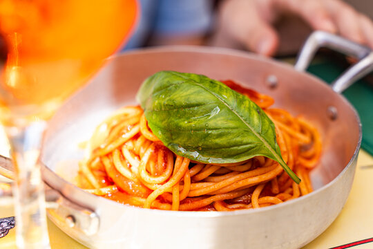 Italian pasta with tomato sauce and fresh basil leaf