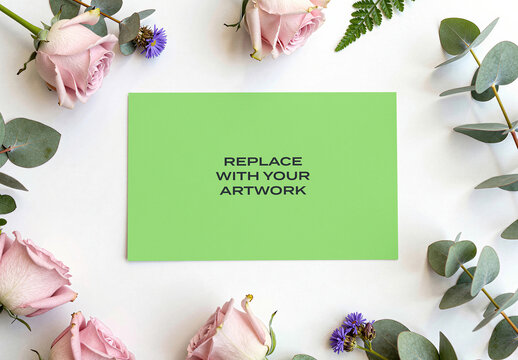 Rectangular card mockup with placeholder text surrounded by pink roses and eucalyptus on a white surface, stationery branding presentation, print design template, flat lay composition, top view