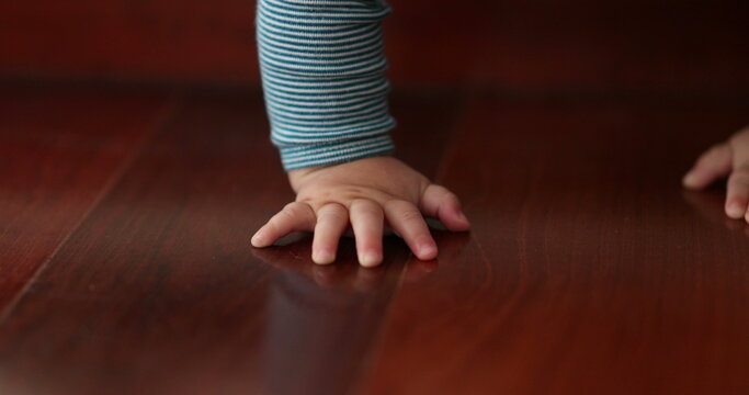 Baby toddler climbing down doorstep stair, infant learning and development